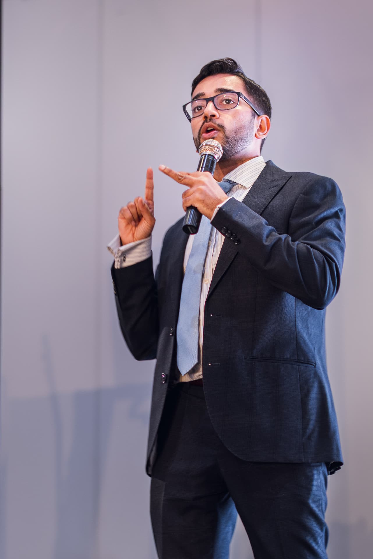 Speaker presenting on stage at the Monaco Investment Summit