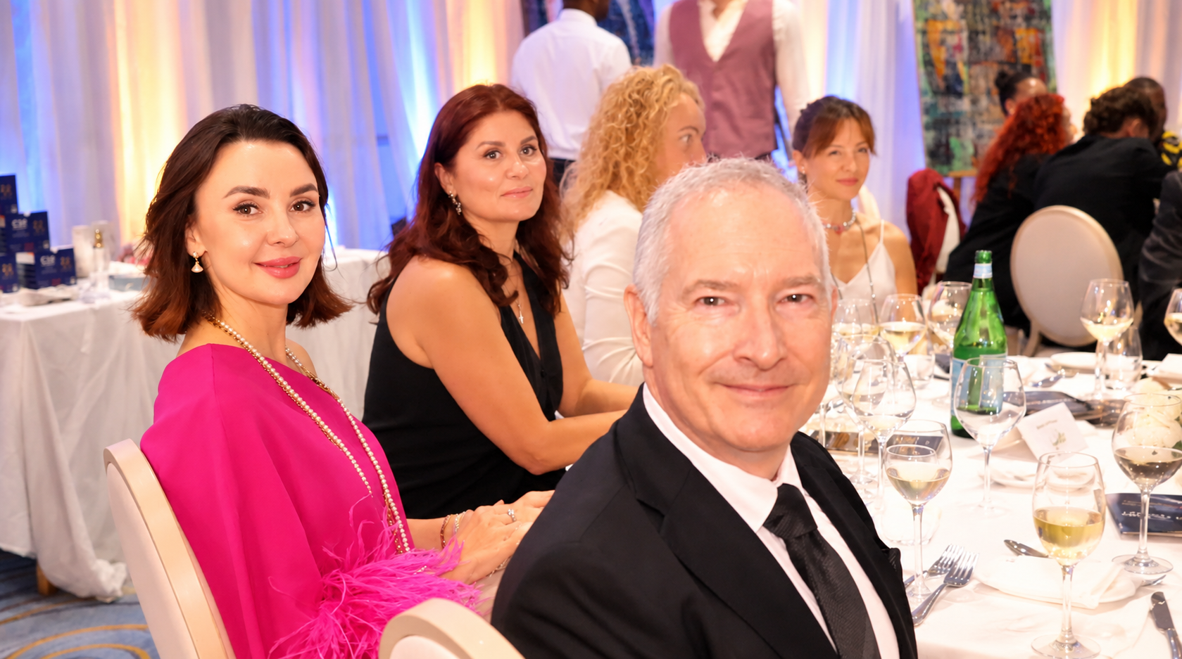 Guests posing at their table during the Summit gala