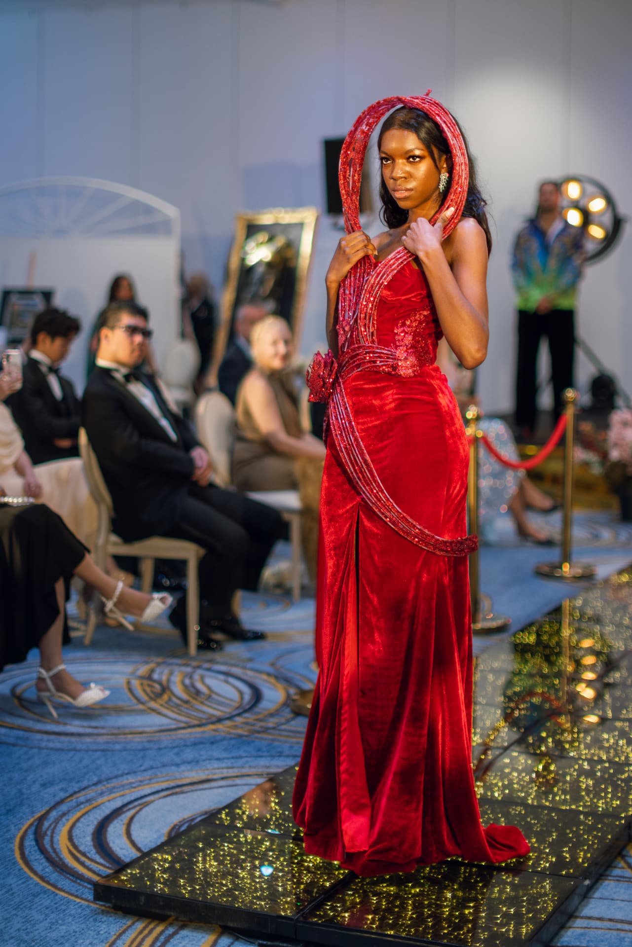 Model in a red velvet gown on the Summit runway