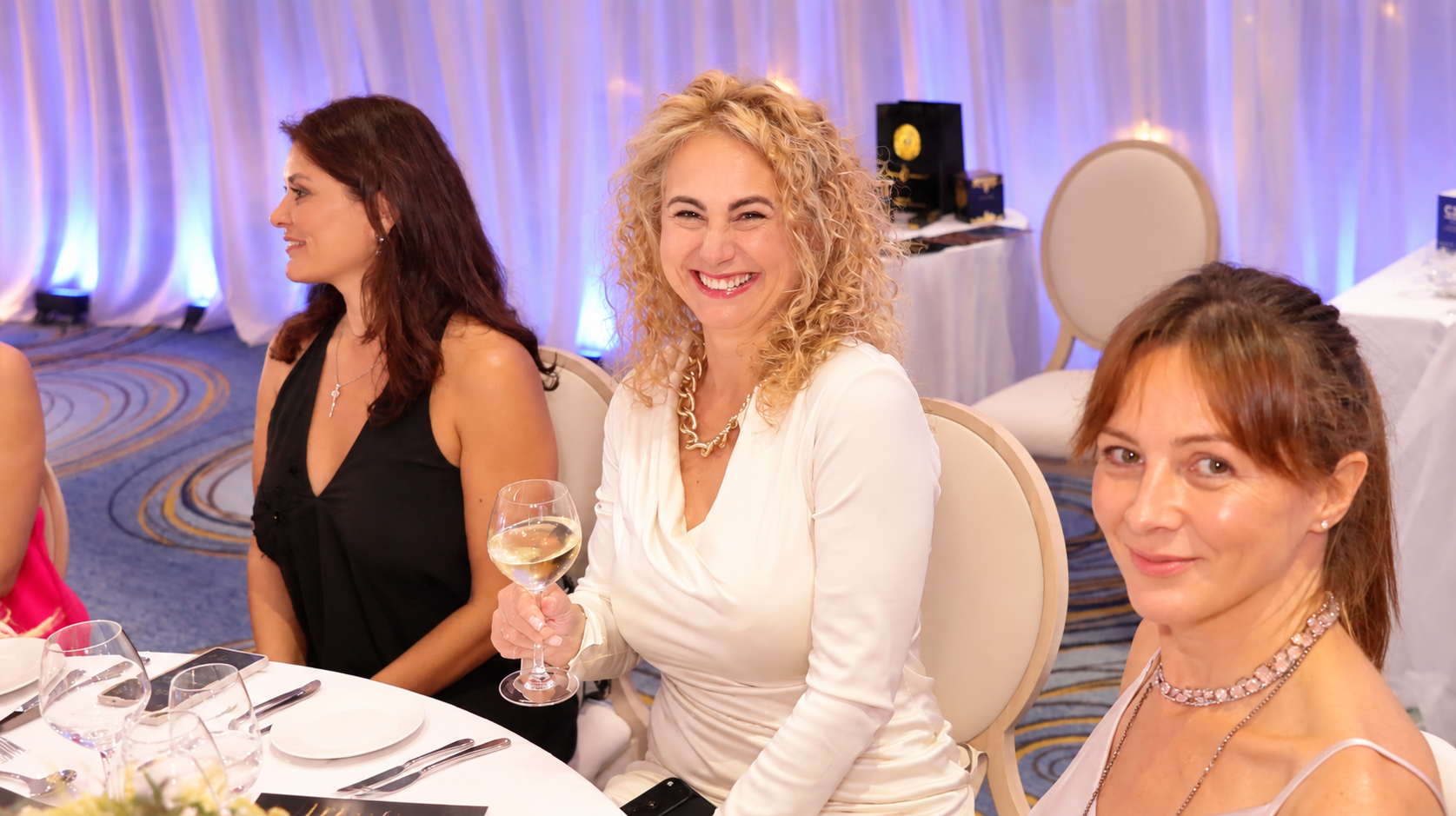 Three guests enjoying the Summit gala dinner