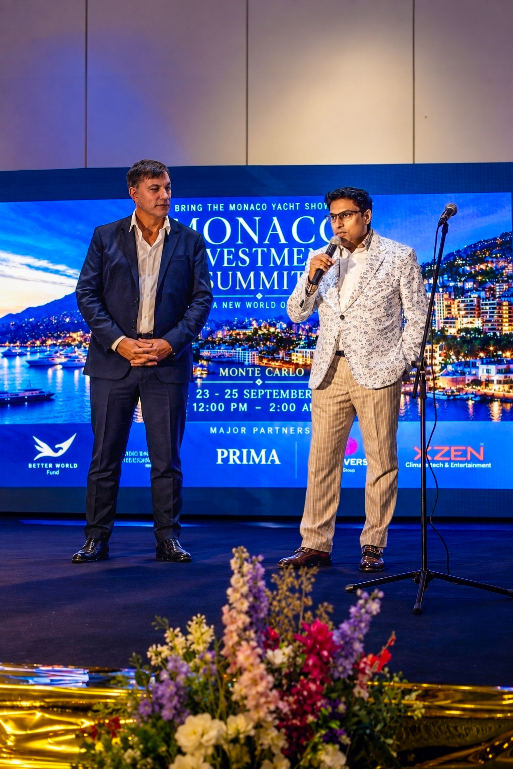 Speakers on the Summit stage with the Monaco Investment Summit backdrop
