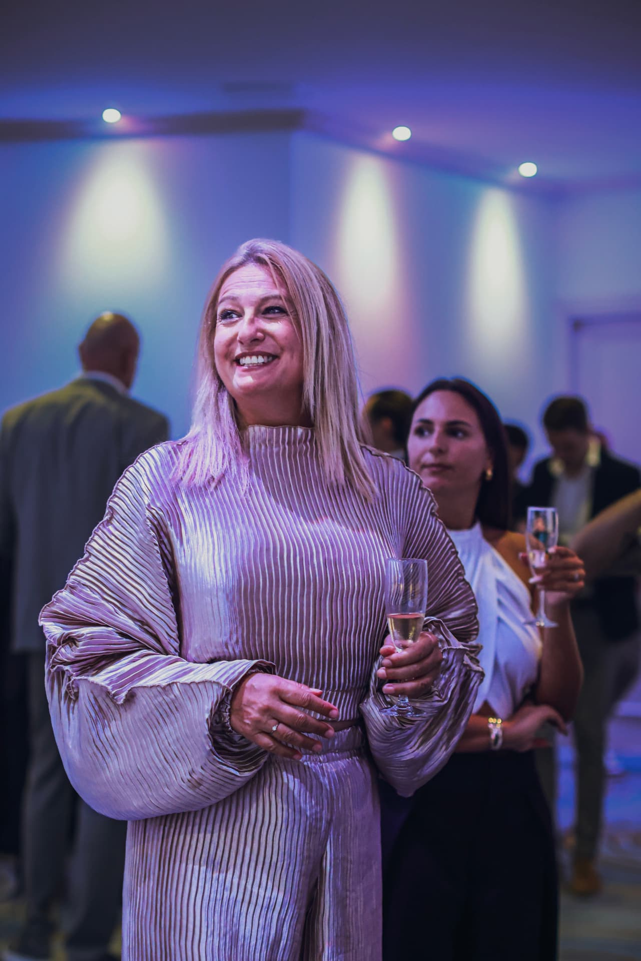 Guest with champagne at the Summit reception