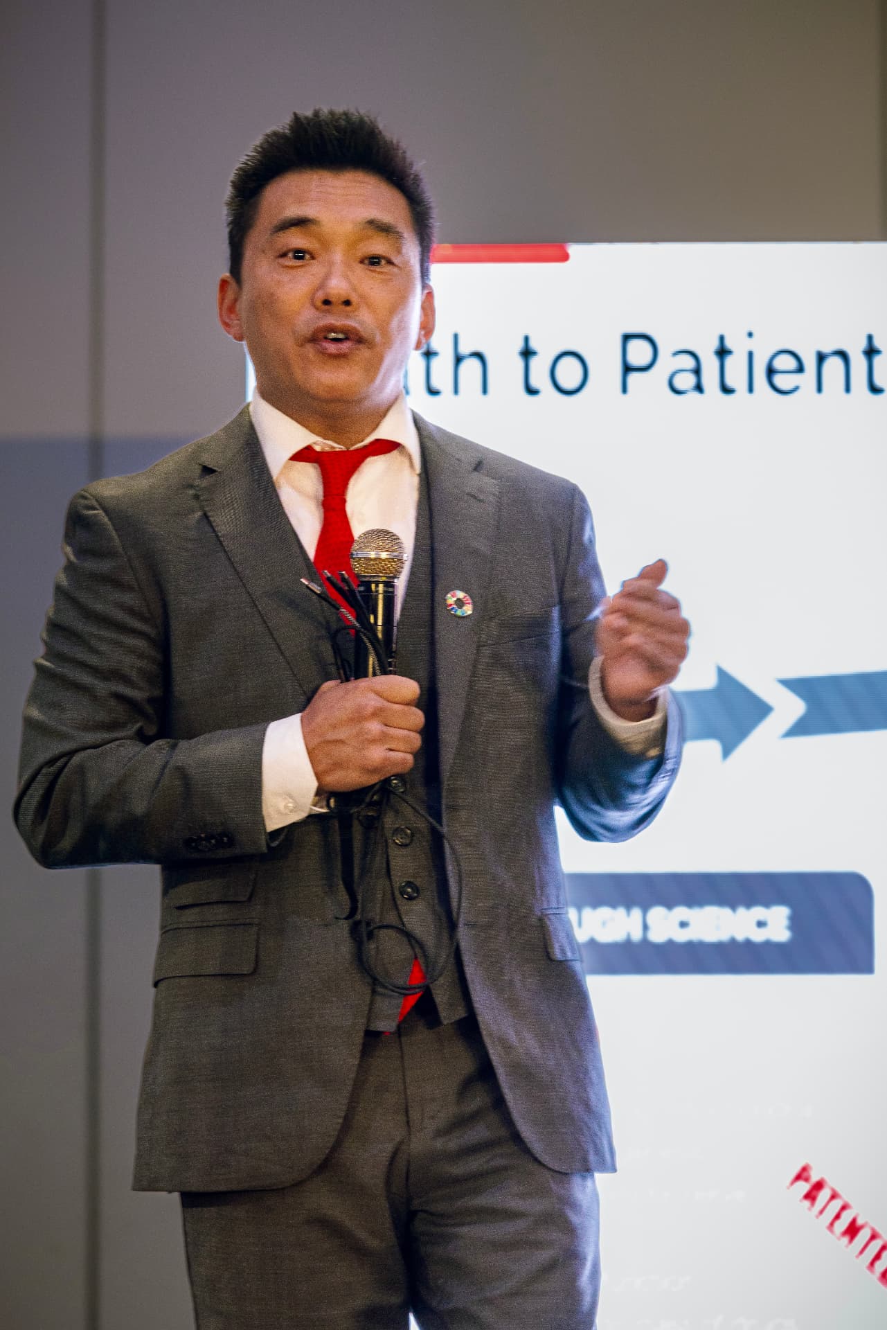 Speaker presenting the health-to-patient briefing on the Summit stage
