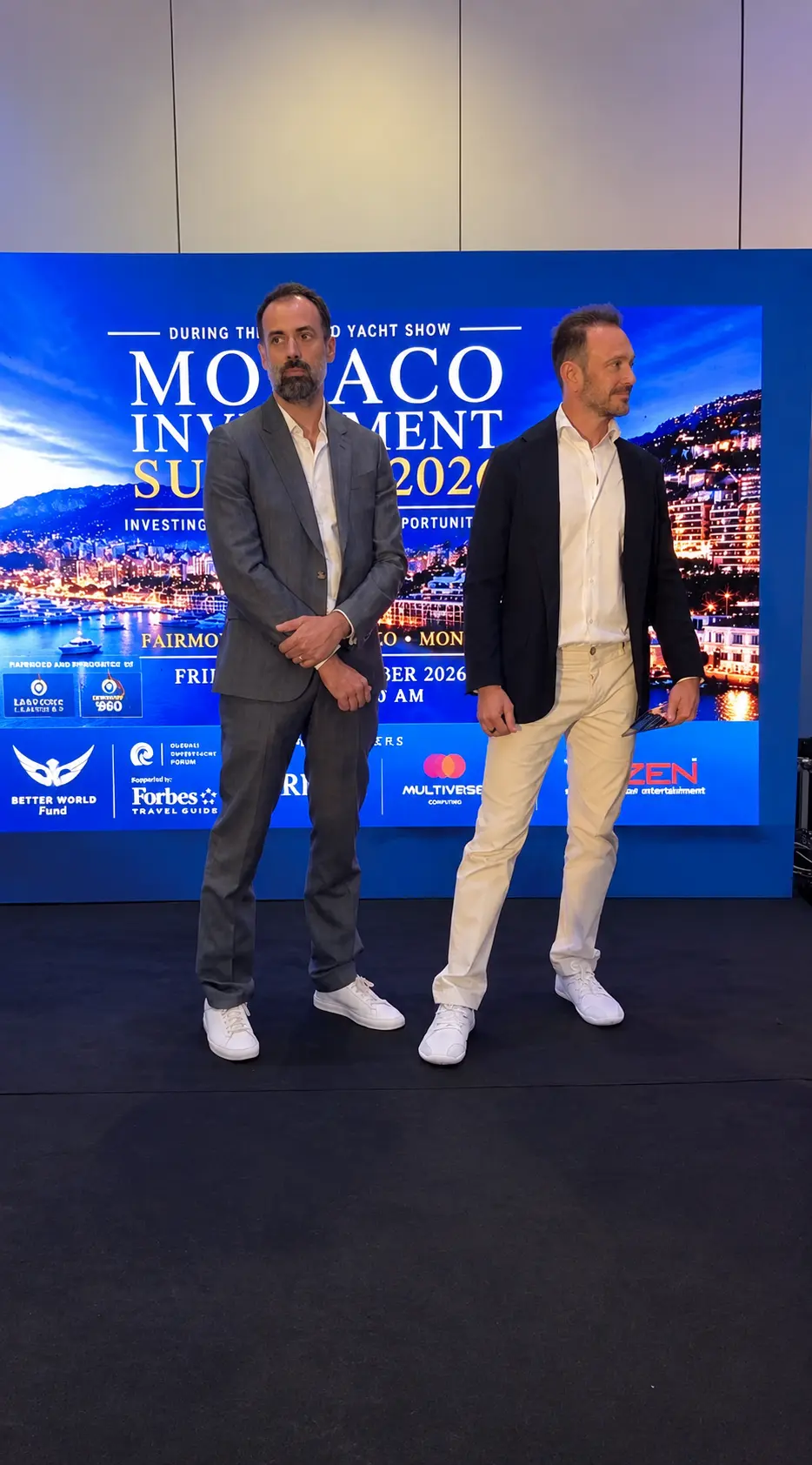 Two guests in front of the Monaco Investment Summit 2026 screen