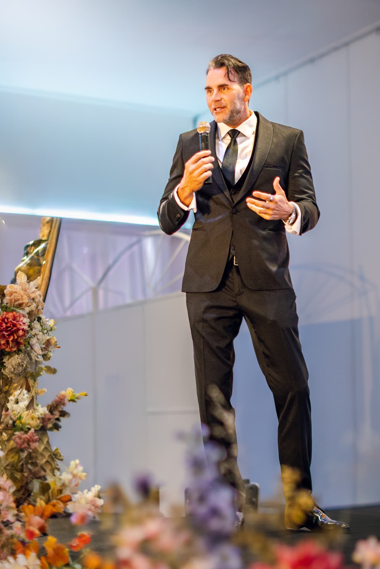 Speaker in black tie addressing the Summit gala