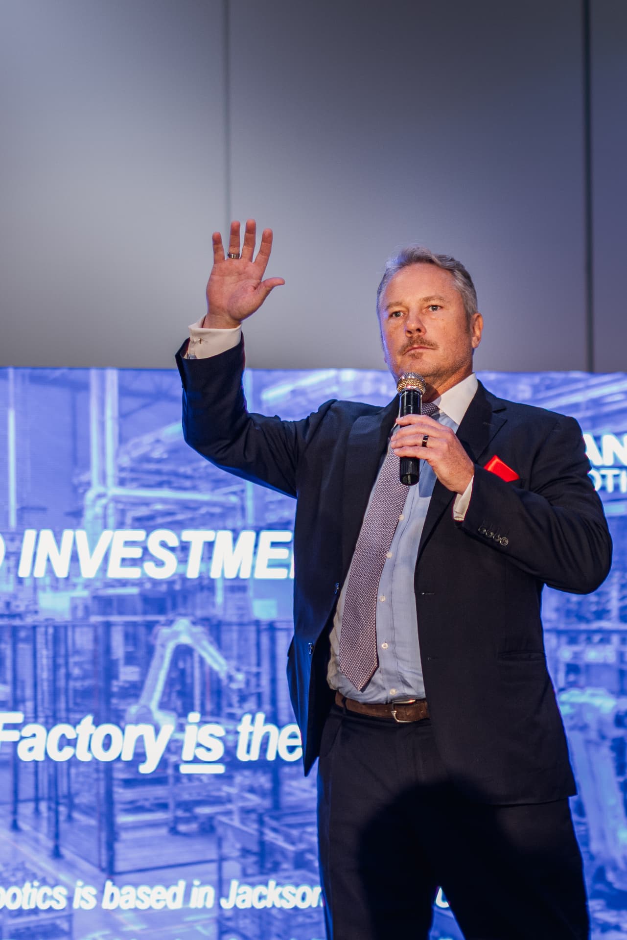 Speaker gesturing to the Summit audience